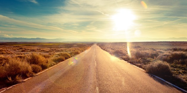 Road through landscape. Road and car travel scenic and sunset.